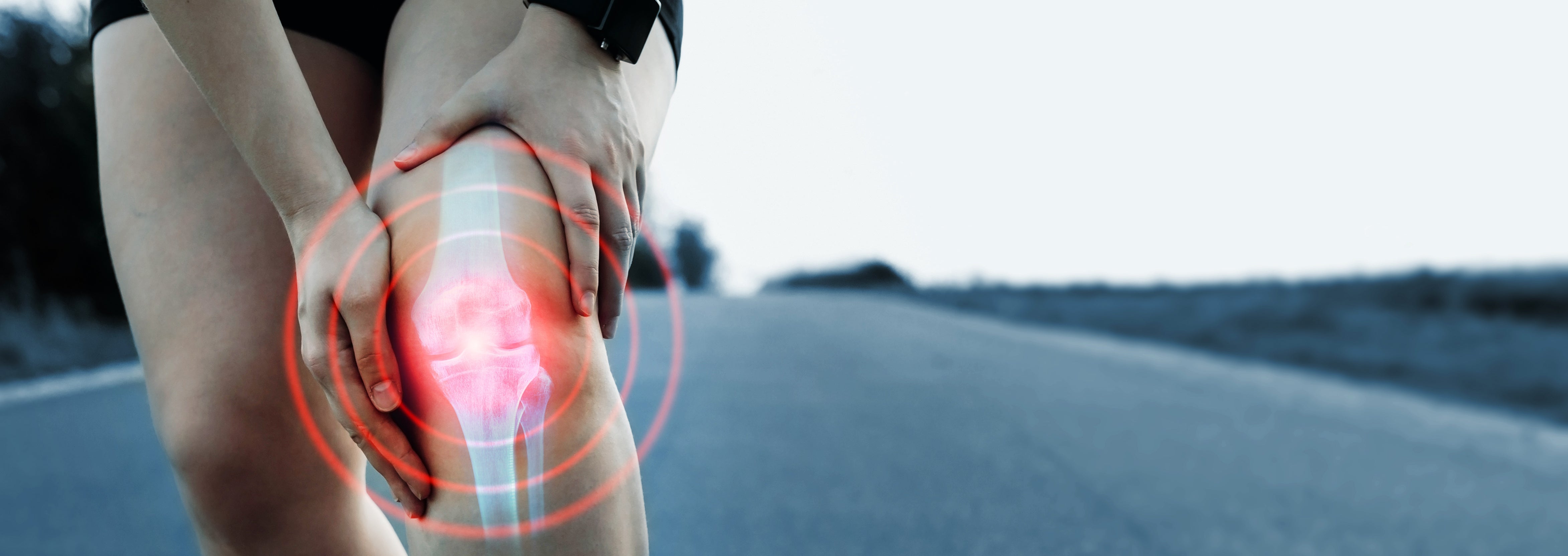 woman holding knee which shows red joint pain