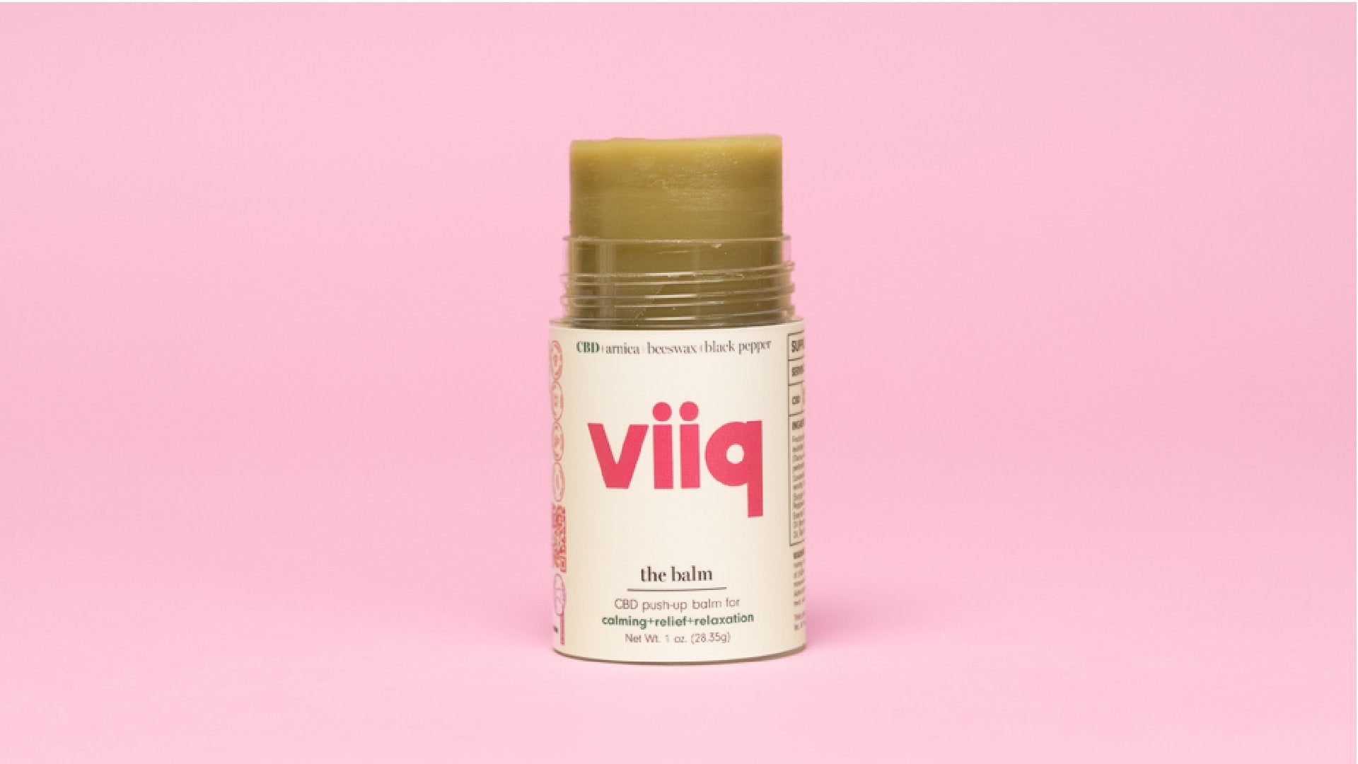 photo of The Balm a natural green solid in a push up stick with pink VIIQ logo