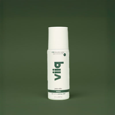 white bottle with dark green bakground and vertical viiq logo cbd oil for extra relief