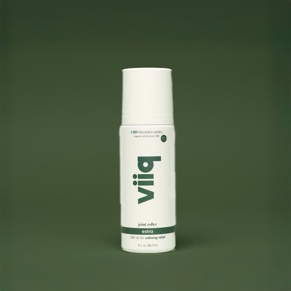 white bottle with dark green bakground and vertical viiq logo cbd oil for extra relief